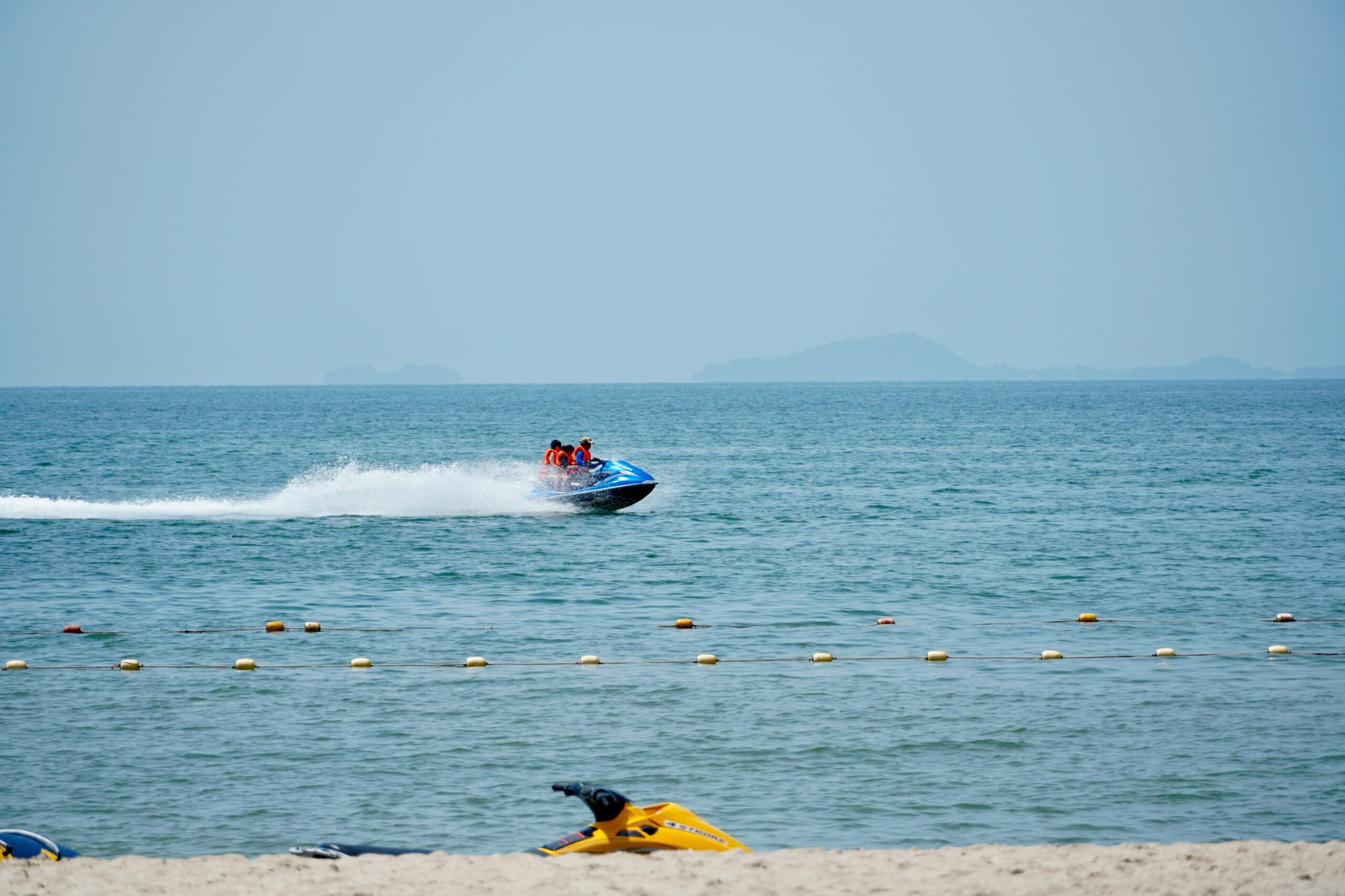 A thrilling jet ski ride on calm ocean waters on a sunny day.
